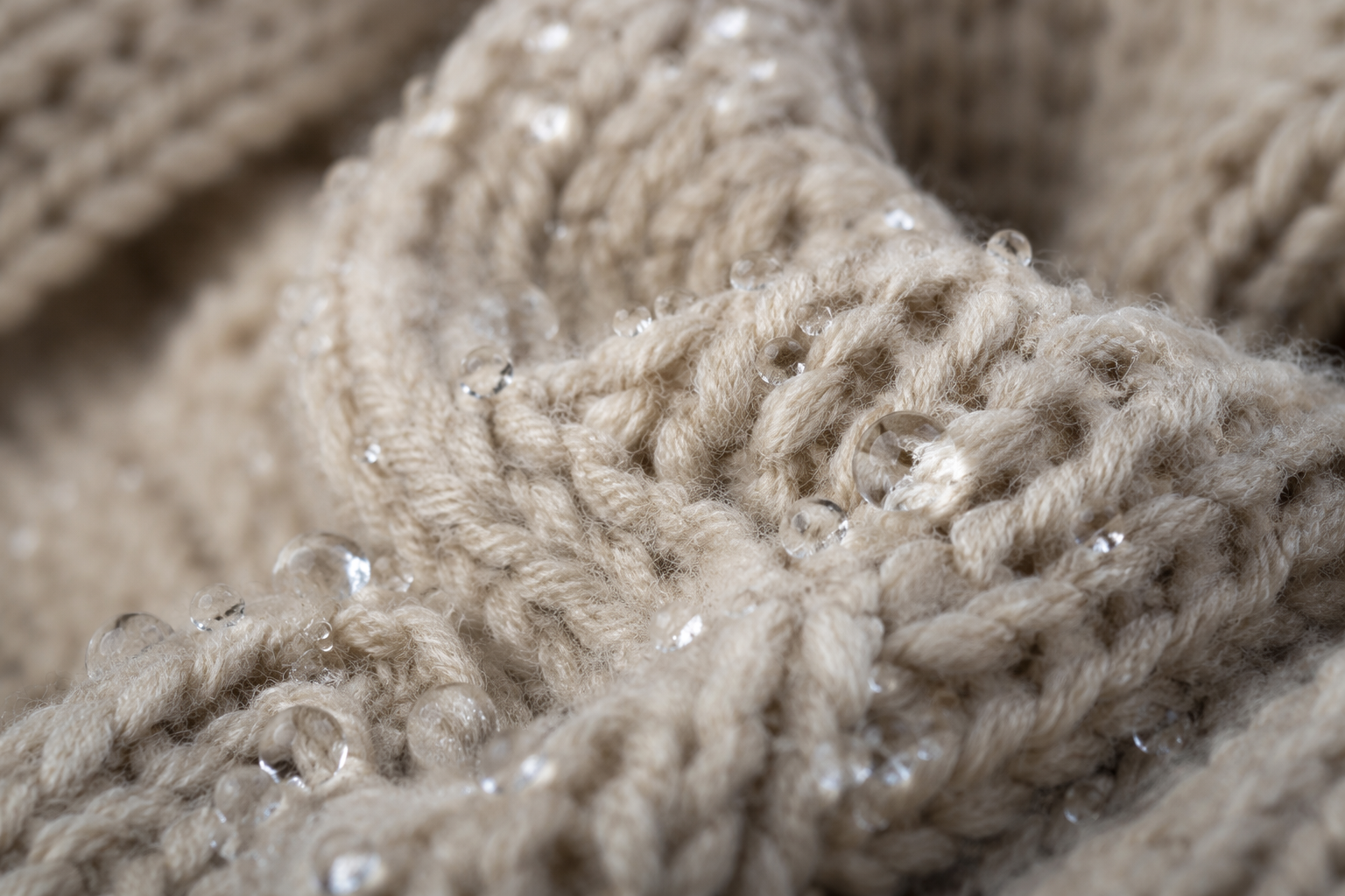 sweater with water droplets beading on yarn surface